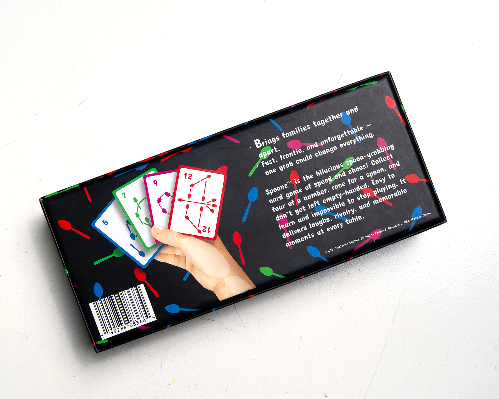 Spoonz box back with a hand holding four number cards