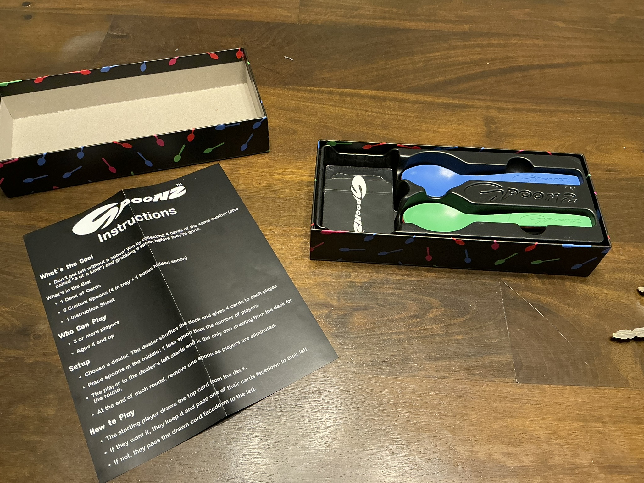 Spoonz box opened with cards, spoons, and instruction sheet